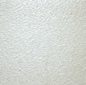 A white wall with some kind of substance on it