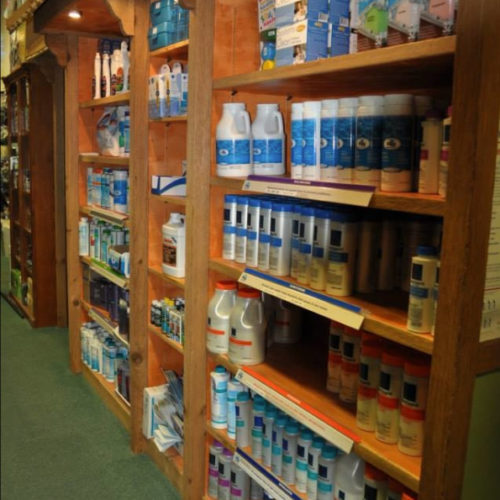 A store with many shelves of bottled water.