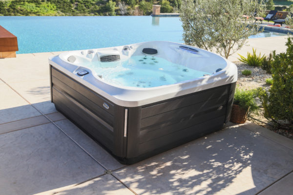 A hot tub sitting on top of a concrete patio.