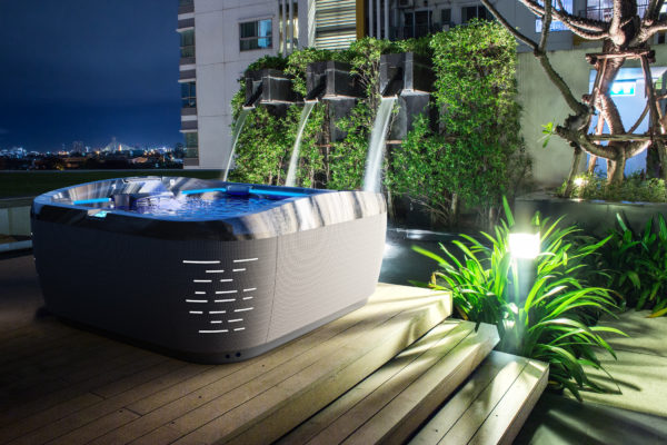 A hot tub sitting on top of a wooden deck.