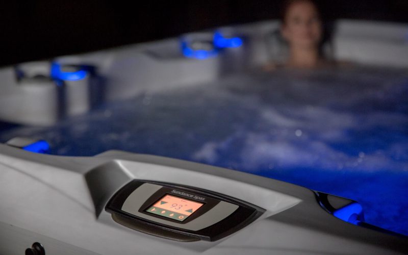 A woman sitting in the tub with her head up.