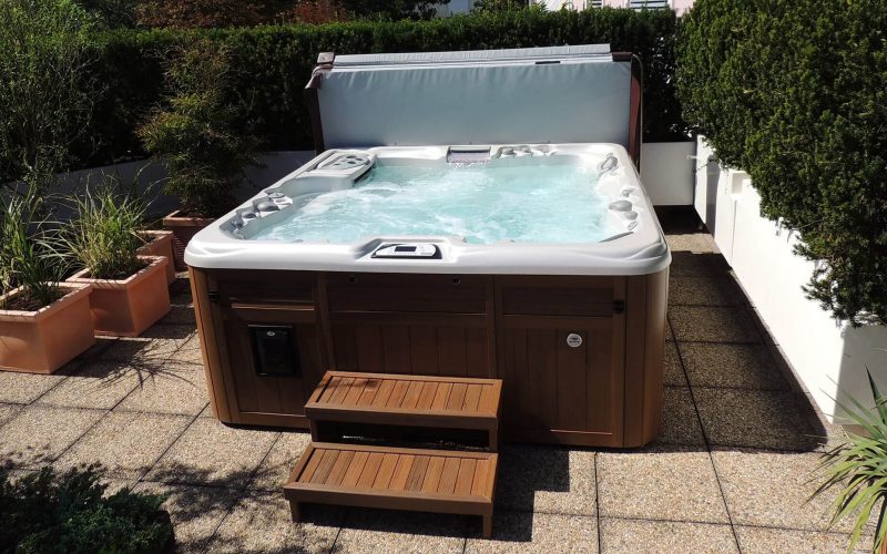 A hot tub sitting on top of a patio. A hot tub sitting on top of a patio.