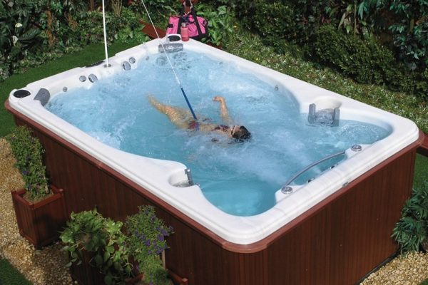 A person in the water of an outdoor spa.