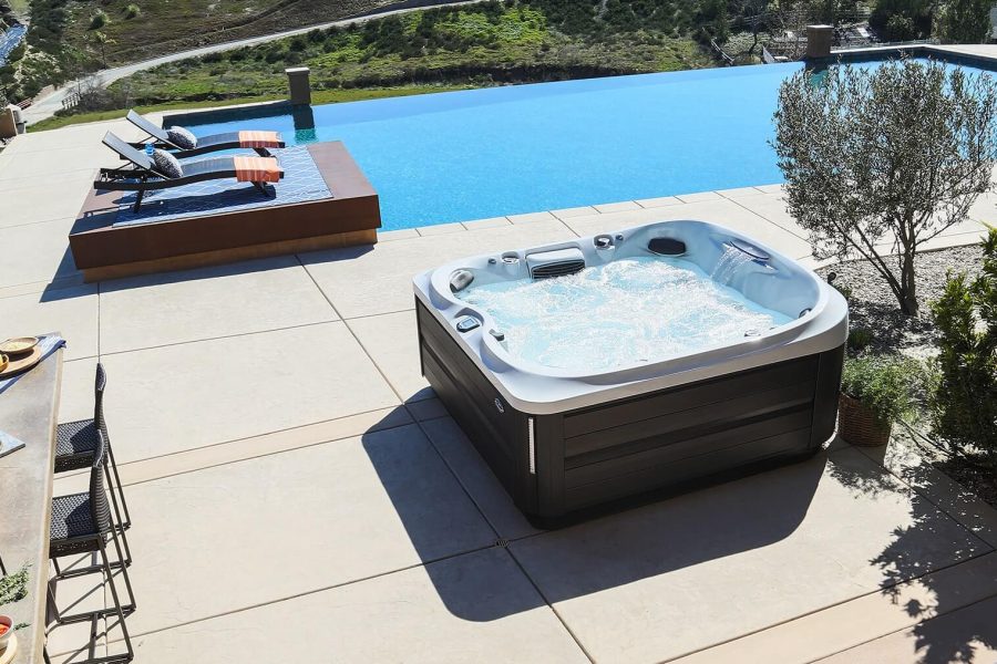 A hot tub sitting next to the pool.