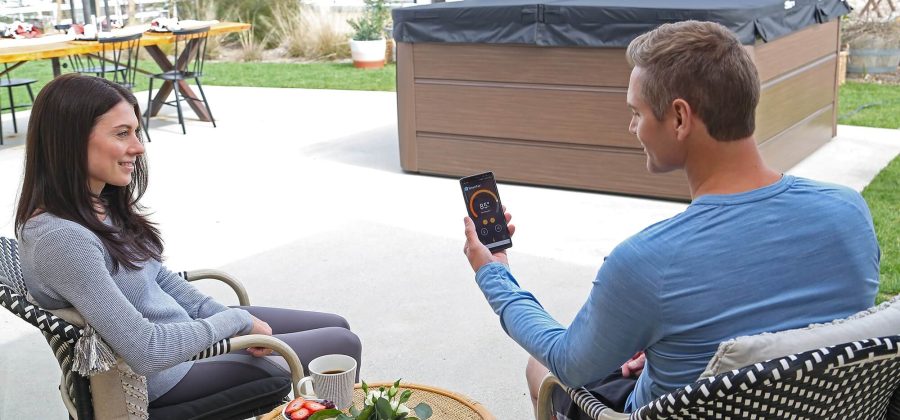 A man sitting on top of a chair next to a woman.